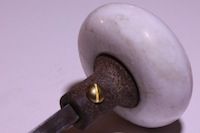 photo of a vintage marble door handle and brass set screw