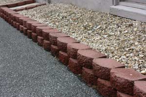 photo of interlocking bricks around a rock garden