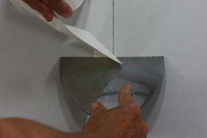 photo cutting paper drywall tape square with a joint knife