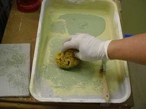 photo demonstrating using a paint tray to prepare a sponge for painting