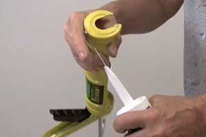 photo demonstrating how to pierce the seal in a tube of caulk