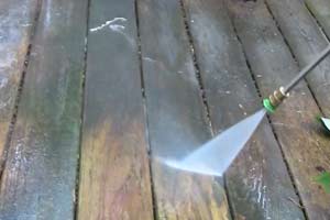 photo cleaning a deck with a pressure washer