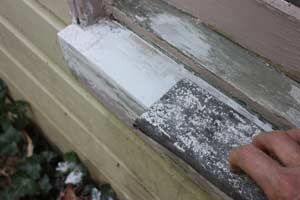 photo sanding hardened epoxy on a windowsill