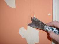 photo demonstrating how to scrape peeling paint off a wall