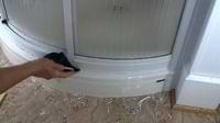 photo demonstrating how to dissolve silicone caulk around a shower stall